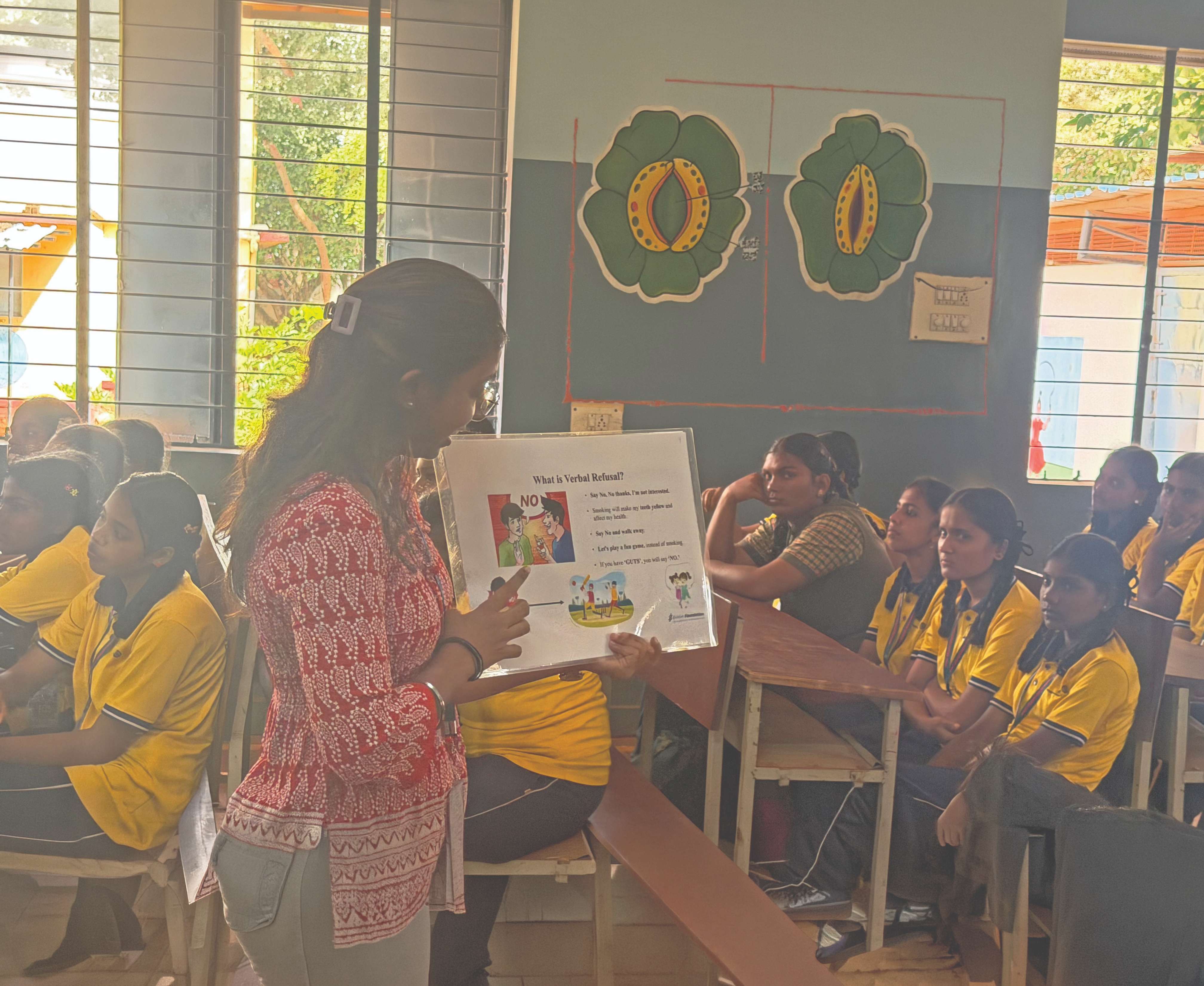 A Syngene volunteer leading an awareness session at a government school